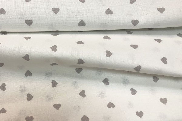 Tessuto Cotone fantasia Cuori su base panna