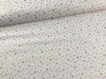 Tessuto in cotone con stelle oro